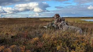 Hunter glassing on prairie