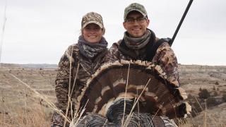Author and husband with turkey after a hunt