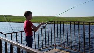 Child Fishing on Pier