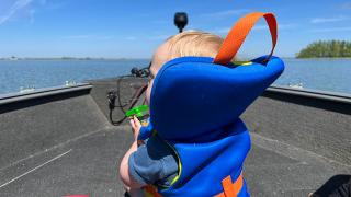 Fisch in the boat watching the water go by