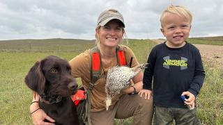 Cayla with dog and son after successful grouse hunt