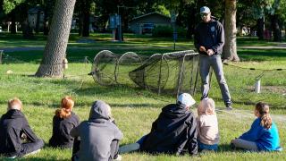Fisheries biologist talking to kids at fish camp