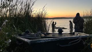  Duck hunters with decoys and a boat